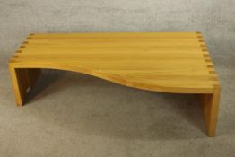 A matched pair of modernist shaped contemporary teak low occassional tables. H.35 x W.136 x D.84 cm.