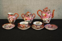 A 20th century Chinese porcelain part teaset with floral decoration, bearing Chinese character marks