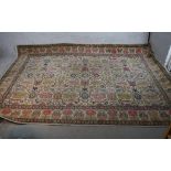 A large beige ground Persian carpet with all over stylistic floral design. W.220 L.327cm