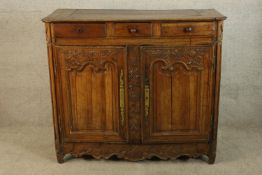 A 19th century French mahogany three drawer over twin door cabinet raised on shaped supports. H.