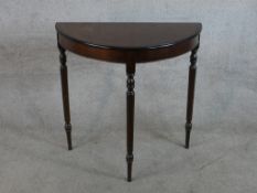 A George III style mahogany demi lune side table raised on turned supports. H.76 W.76 D.36cm