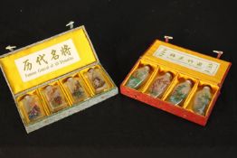 A boxed set of four 20th century Chinese glass painted scent bottles and stoppers entitled Famous