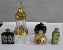 Six assorted 20th century glass and gilt metal mounted scent bottles and stoppers. H.13 W.4cm