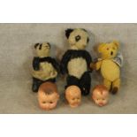 Three 20th century painted papier mache dolls heads, together with a 20th century teddy bear with