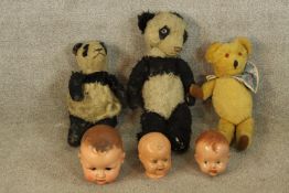 Three 20th century painted papier mache dolls heads, together with a 20th century teddy bear with