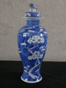 A Chinese blue and white porcelain vase and cover decorated with prunus blossom surmounted with