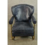 A contemporary brass framed and faux blue leather crocodile skin effect open arm chair.