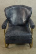 A contemporary brass framed and faux blue leather crocodile skin effect open arm chair.