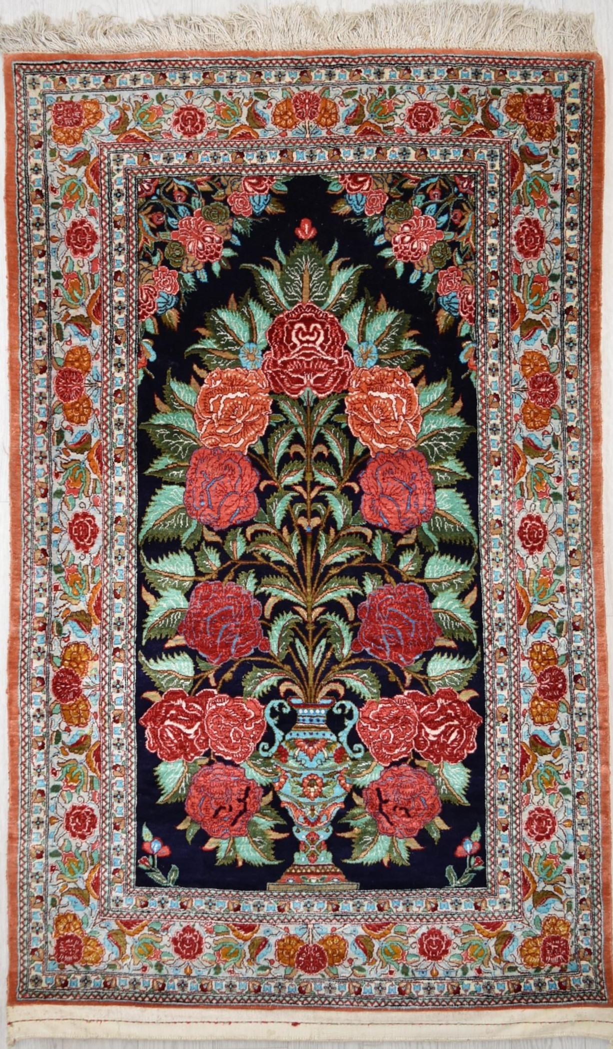 A contemporary Iranian/Persian silk Qum (Qom) tree of life design rug, the central black field
