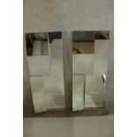 A pair of contemporary multi faceted rectangular wall mirrors. H.102 W.42cm. (each)