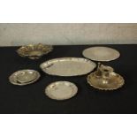 Assorted silver plated items to include a chamberstick, dishes and a pierced basket with swing