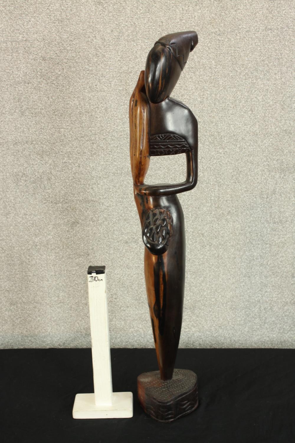 A 20th century carved African hardwood tribal figure raised on shaped base. H.73cm. - Image 2 of 3