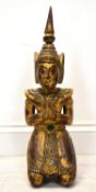 A 20th century gilt painted hardwood kneeling Thai Buddha. H.51cm