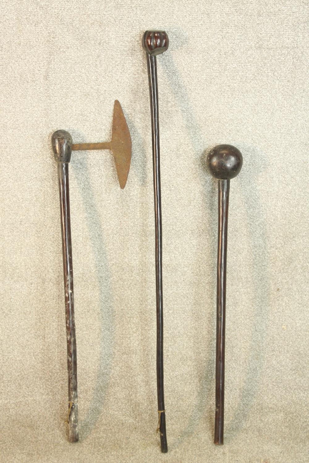 A 20th century South African Zulu knobkerrie together with a hardwood handled and iron axe and one