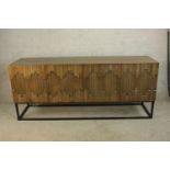 A contemporary pine Dovetail Mabini four door sideboard raised on metal framed base. H.88 W.204cm.