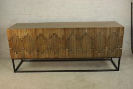 A contemporary pine Dovetail Mabini four door sideboard raised on metal framed base. H.88 W.204cm.