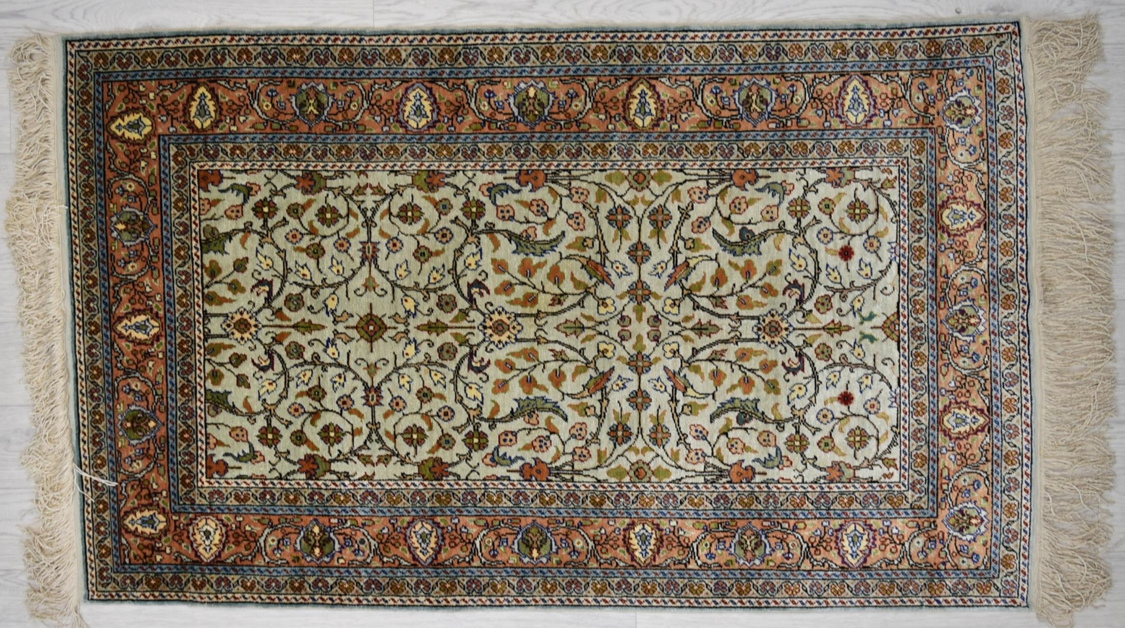 A 20th century Persian/Iranian silk Qom (Qum) rug, the ivory field with tree of life pattern
