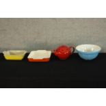 A yellow ceramic Le Creuset oven dish together with a ceramic bowl, over dish and red ceramic Le