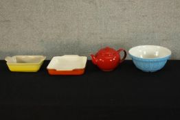A yellow ceramic Le Creuset oven dish together with a ceramic bowl, over dish and red ceramic Le