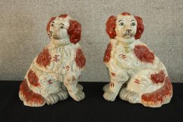 A large pair of 19th century Staffordshire pottery seated dogs. H.28cm (each)