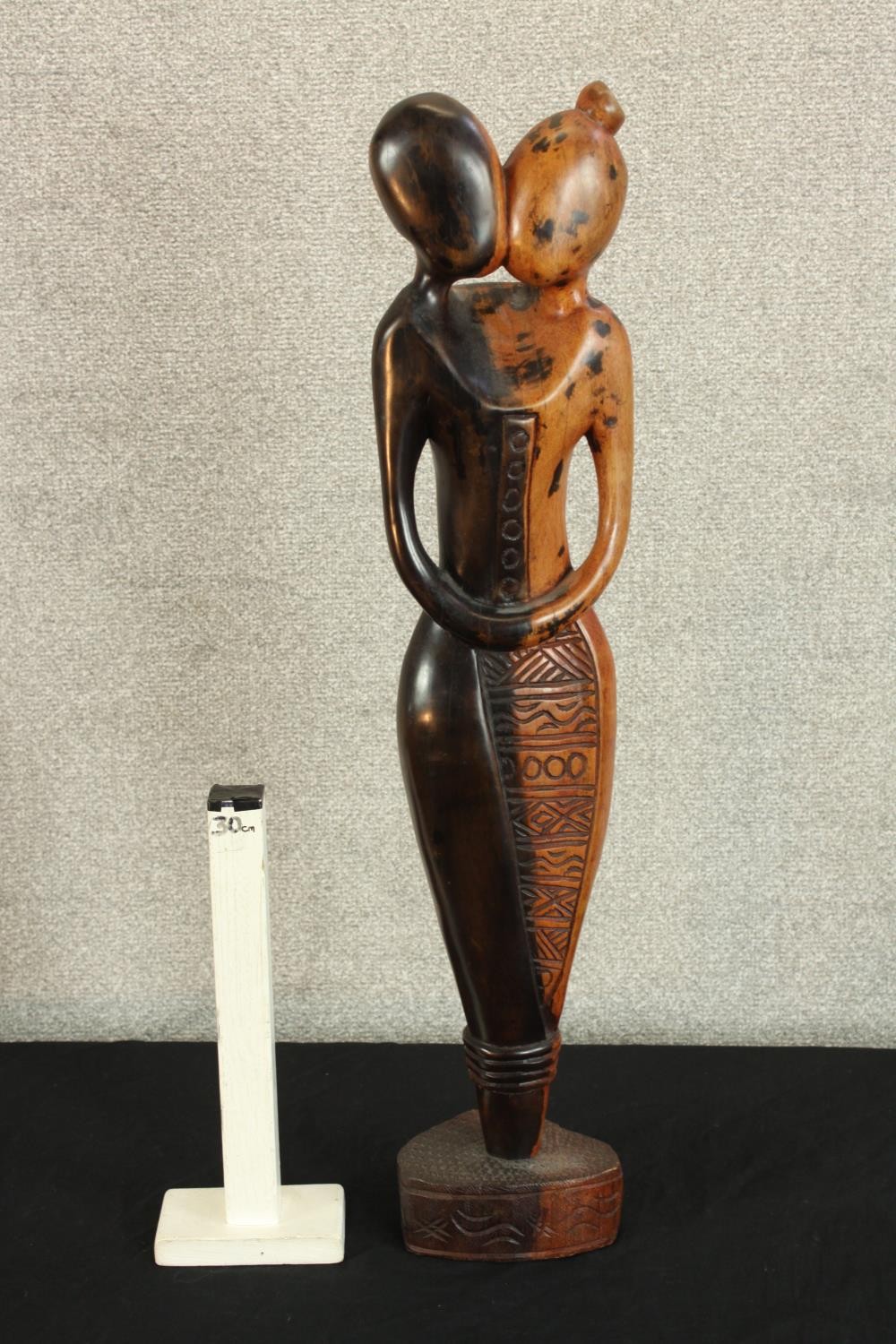 A contemporary carved African hardwood tribal figure of a kissing couple, raised on shaped plinth. - Image 2 of 3