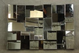 A contemporary multi faceted rectangular wall mirror. H.84 W.121cm.
