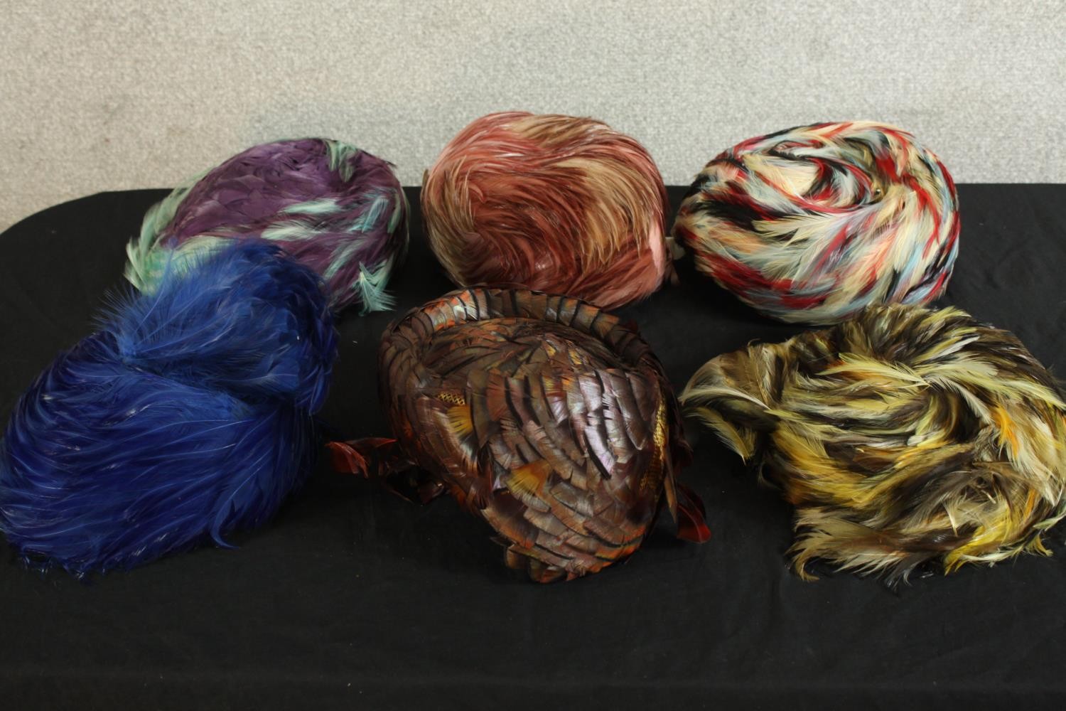 A collection of six 20th century style feathered women’s hats.