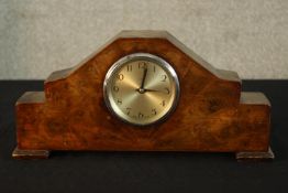 An Art Deco walnut cased eight day mantle clock raised on shaped bracket feet. H.18cm.