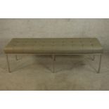 A contemporary Knoll style button grey leather seated bench raised on chome plated square