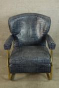A contemporary brass framed open arm chair upholstered in blue crocodile skin effect material raised