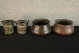 Two 20th century Indian hammered copper cooking pots, together with a pair of Middle Eastern iron