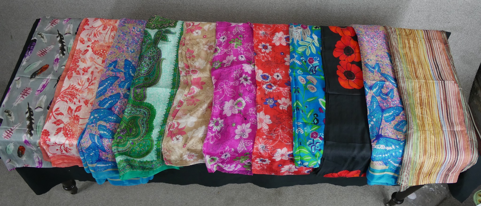 Eleven assorted vintage patterned silk scarves.