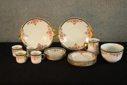 A mid 20th century porcelain part teaset, painted with iron red sprays of flowers, marks to the