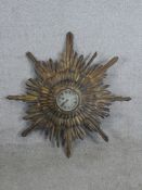 A 20th century carved and gilt painted sunburst wall clock, the silvered dial with black Roman