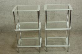 A pair of chrome plated and glass three tier stands, each raised on cylindrical supports. H.75 W.