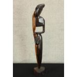 A 20th century carved African hardwood tribal figure raised on shaped base. H.73cm.