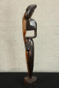 A 20th century carved African hardwood tribal figure raised on shaped base. H.73cm.