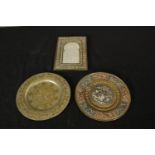 Two 20th century brass and copper trays together with a small engraved Indian brass picture frame.