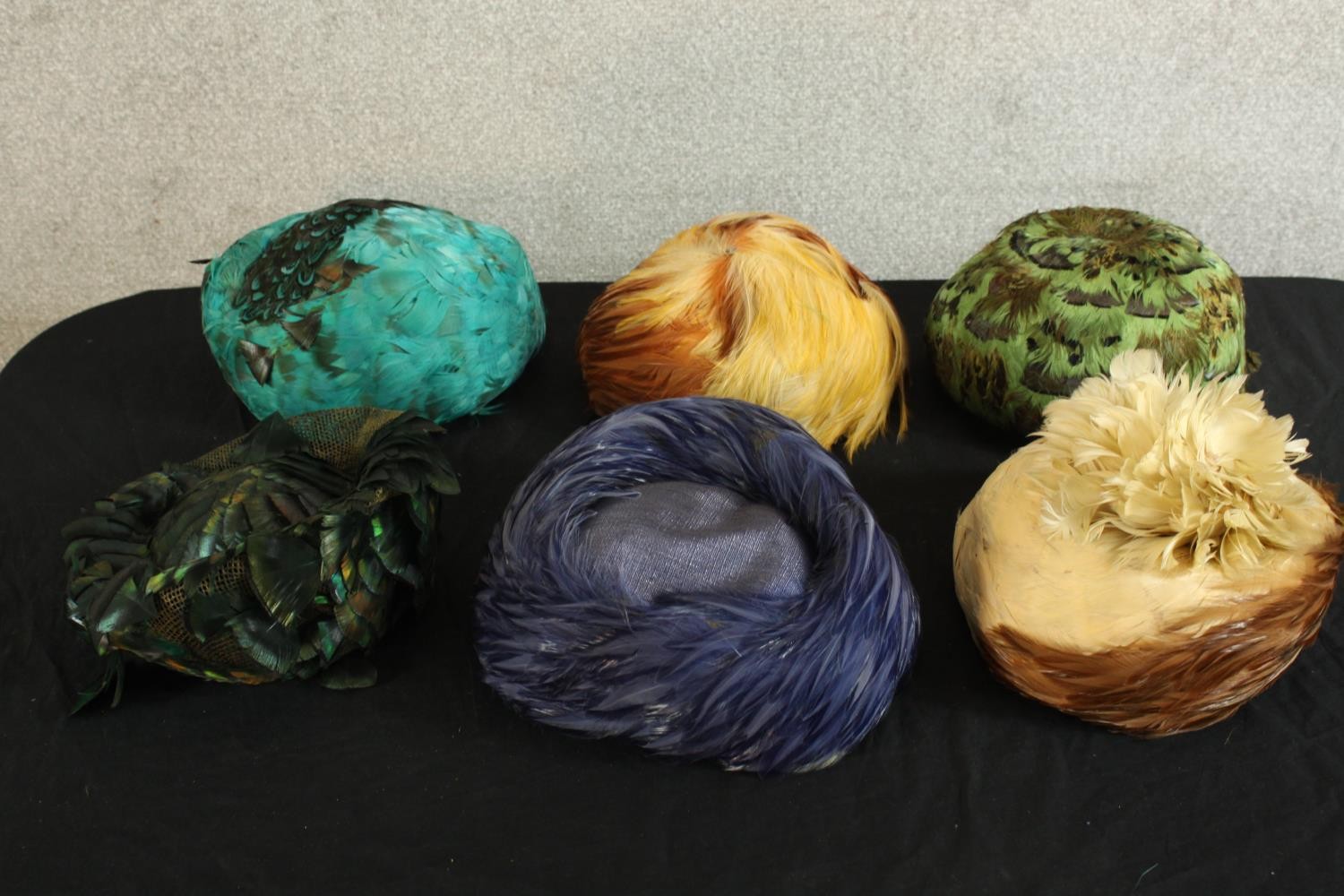 A collection of six 20th century style feathered women’s hats.