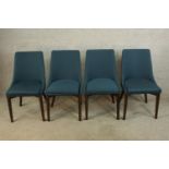 A set of four teak framed upholstered dining chairs raised on tapering supports.