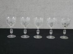 A set of five cut glass drinking glasses, the central knop stem raised on 'star' incised base. H.