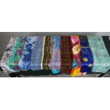 Twelve assorted vintage patterned silk scarves.