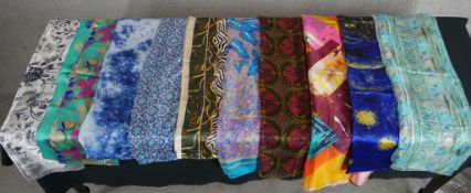 Twelve assorted vintage patterned silk scarves.