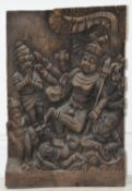 A carved South East Asian hardwood panel depicting a multi armed Bodhisattva with figures at his