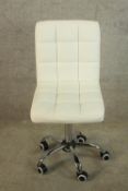 A 20th century quilted white faux leather and chrome childs desk chair with central column raised on