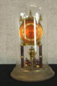 A mid 20th century brass Anniversary clock raised on stepped circular base with glass dome. H.32cm.