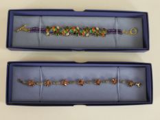 Two boxed gem-set bracelets, one with a pierced gold plated cockatoo design with colourful enamel,