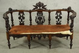 An early 20th century Eastern influence inlaid mahogany open framed sofa, with pierced splat back