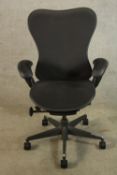 A contemporary Herman Miller adjustable desk chair raised on five splayed supports terminating in
