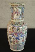 A 19th century Chinese Famille Rose porcelain twin handled baluster vase, decorated with panels of